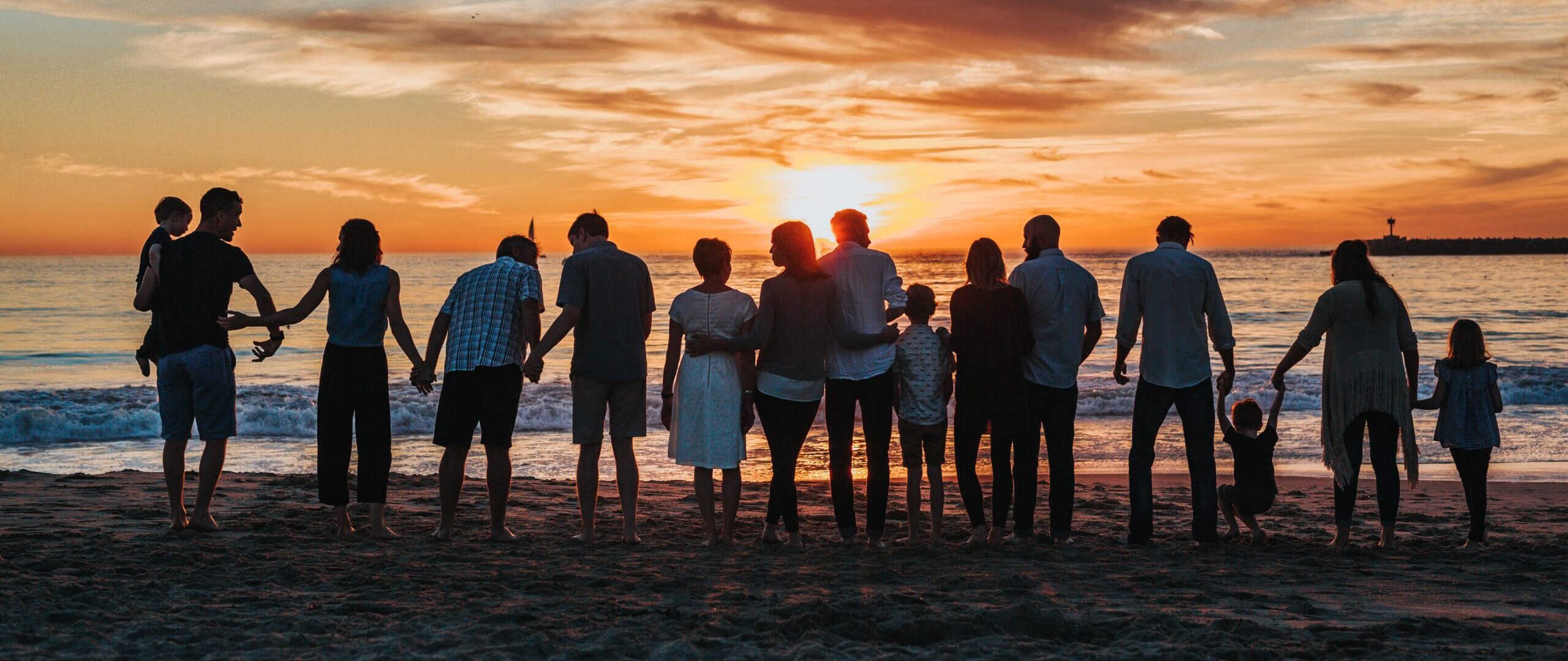 Large multi-generational family looking towards sunset