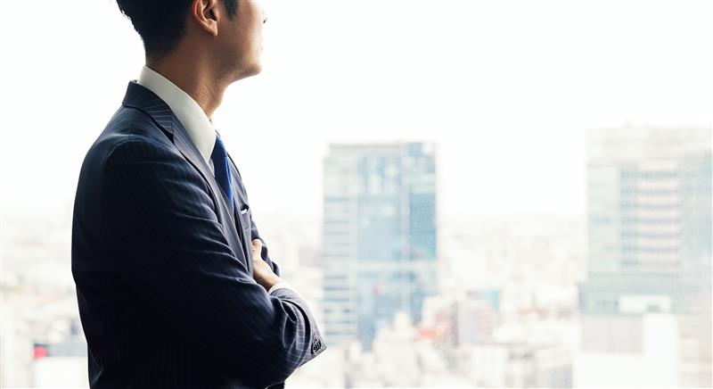 Businessman looking out of office window