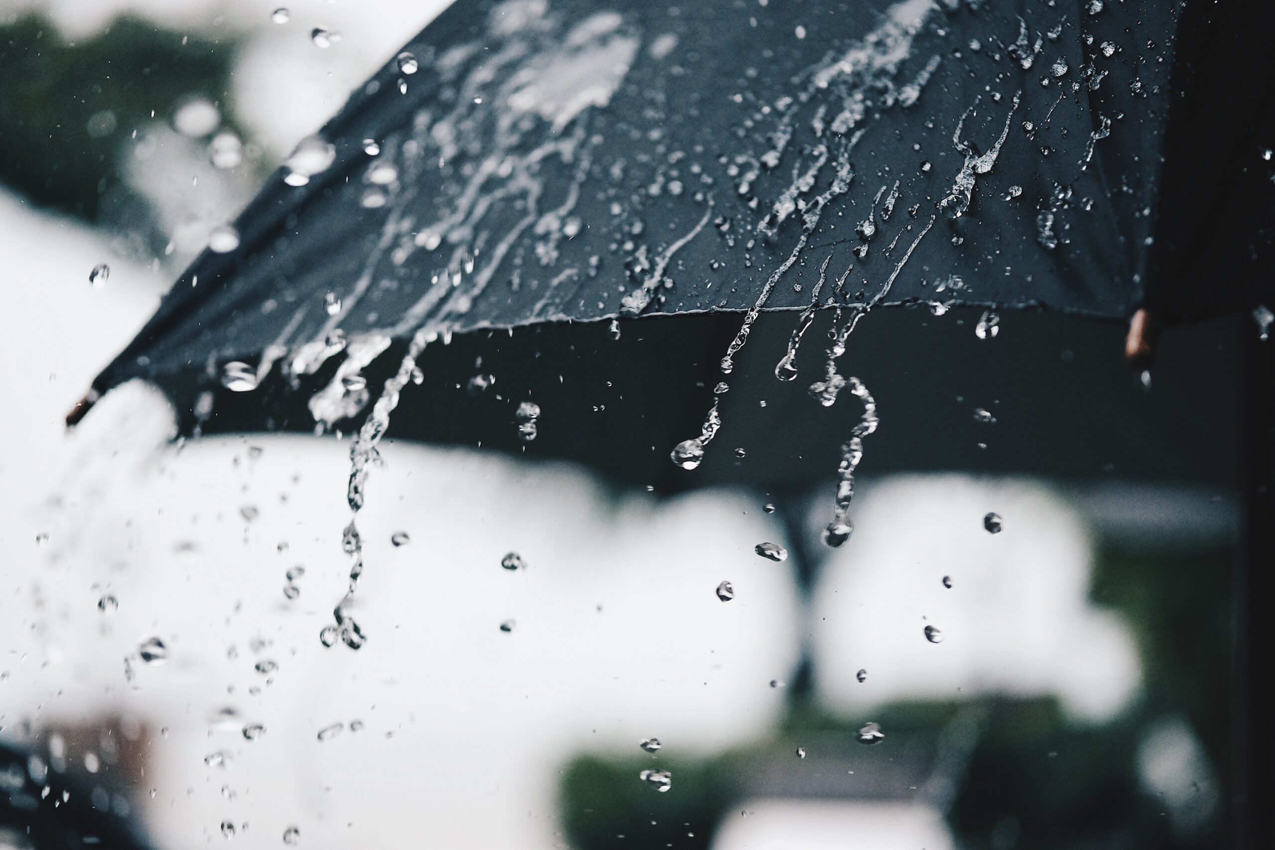 Close up of an umbrella protecting someone from the rain