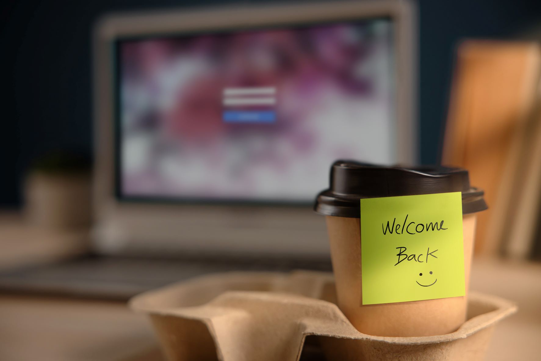 Coffee cup with a sticky note saying 'welcome back'