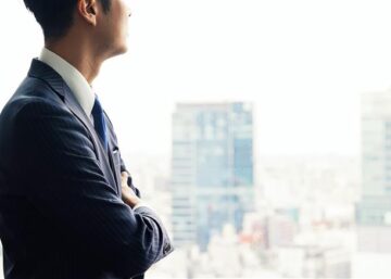 Businessman looking out of office window