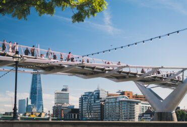 People crossing bridge in London
